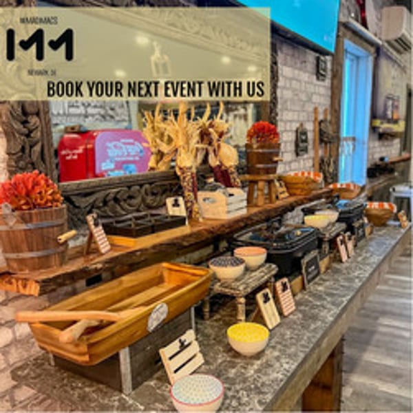 A buffet line at MadMacs with various food warmers, decorative corn, and bowls.
